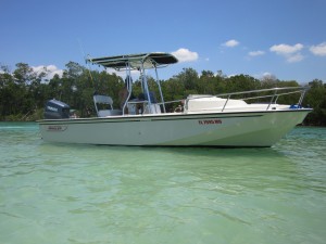 White boat anchored in clear blue water.